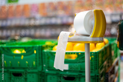 Plastic bag dealer in a supermarket fruit shop.