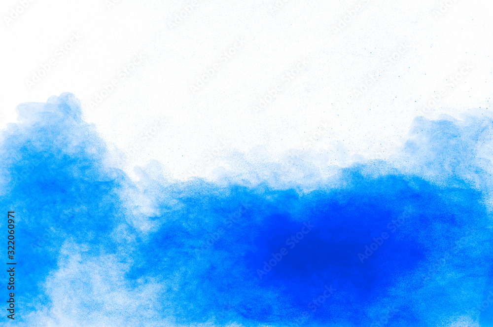 Blue color powder explosion cloud on white background.Closeup of Blue dust particles splash on background.