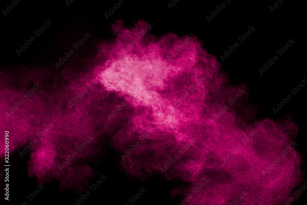 Pink powder explosion on black background.Pink dust splash cloud on dark background.