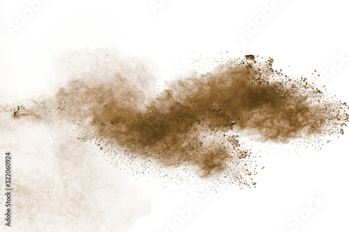 Abstract deep brown dust explosion on white background.Freeze motion of brown dust splash. photo