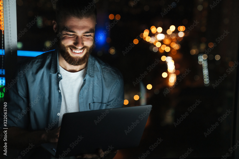 Concentrated young man working on laptop computer Concentrated young man working on laptop computer