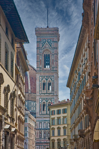 The bell tower of the Il Duomo church in Florence  Italy from a narrow street
