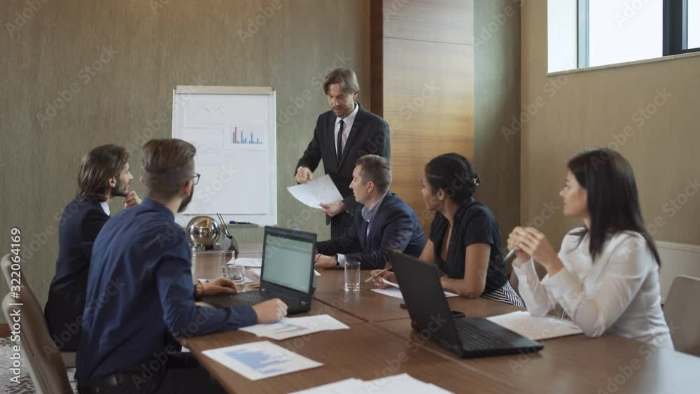 international business meeting, businessman speak at a meeting in the conference room, man in a suit communicates with colleagues, emotional conversation. international business meeting, businessman speak at a meeting in the conference room, man in a suit communicates with colleagues, emotional conversation.