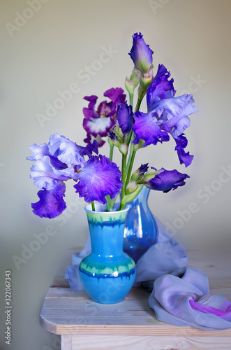 Fotografie Still life with a beautiful bouquet of irises in a vase on the table