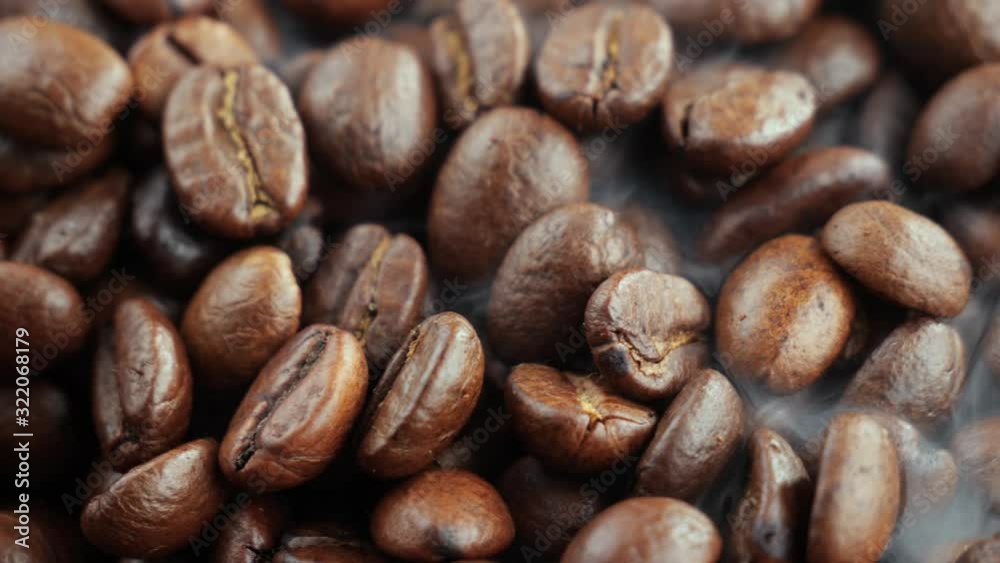 Black coffee beans roast in a pan in the smoke Black coffee beans roast in a pan in the smoke
