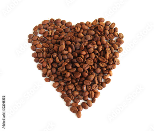 Roasted coffee beans in the shape of the heart.