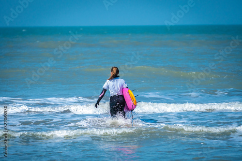 girl with his surfboard