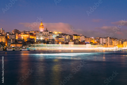 Istanbul, Turkey - Jan 15, 2020: Galata Tower with Ferry Boat in Golden Horn , Istanbul, Turkey, © fazon