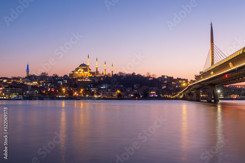 Istanbul, Turkey - Jan 13, 2020: Halic Metro Bridge And Suleymaniye Mosque ,Golden Horn At Night, Istanbul, Turkey photo