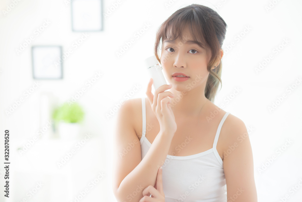 Beautiful portrait young asian woman holding and presenting cream or lotion product, beauty asia girl show cosmetic makeup and moisturizing for skin care, healthy care and wellness concept. Beautiful portrait young asian woman holding and presenting cream or lotion product, beauty asia girl show cosmetic makeup and moisturizing for skin care, healthy care and wellness concept.