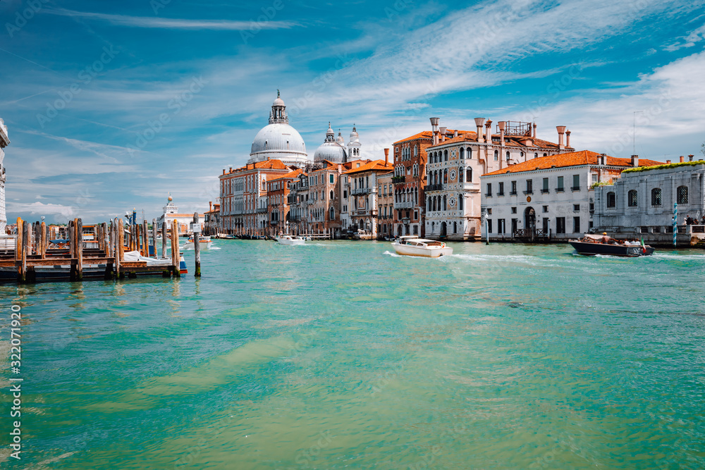 Grand Canal turquoise water and Basilica Santa Maria della Salute against blue sky, Venice, Italy