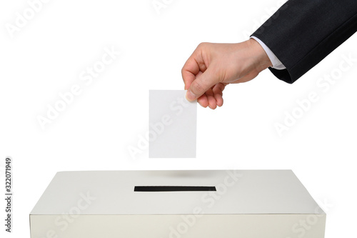 Man's hand down the ballot in the ballot box. photo