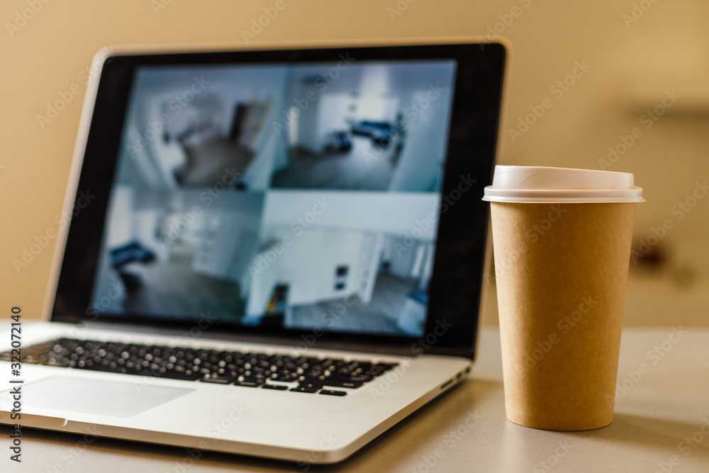 Craft paper coffee cup near laptop, news Craft paper coffee cup near laptop, news