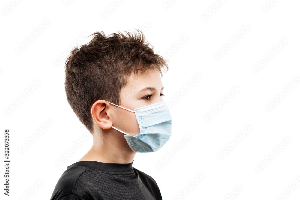 Teenager boy wearing respiratory protective medical mask side view Teenager boy wearing respiratory protective medical mask side view