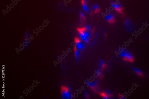 Blurred lens flare. Defocused colorful lights. Shiny glowing spots  abstract background and texture