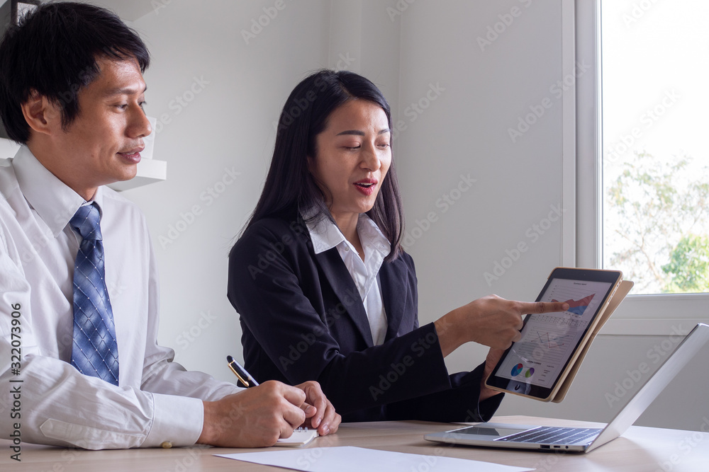 Female Business consultant explains stock information chart for stock trading training for Male Business owners that uses stock trading or SME business growth. Female Business consultant explains stock information chart for stock trading training for Male Business owners that uses stock trading or SME business growth.