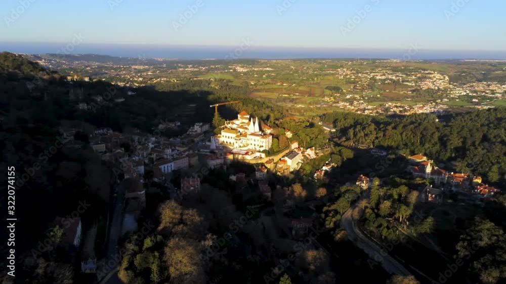 Beautiful palace of Sintra, Portugal, white great walls shining at sunrise, surrounded by green vegetation of city gardens. UNESCO World Heritage Site Beautiful palace of Sintra, Portugal, white great walls shining at sunrise, surrounded by green vegetation of city gardens. UNESCO World Heritage Site