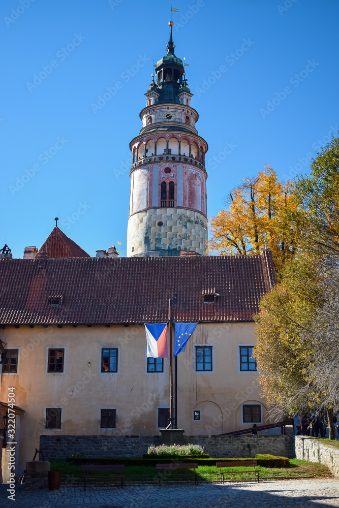 Obraz premium Flags of the Czech Republic and the European Union near an old building and church in autumn