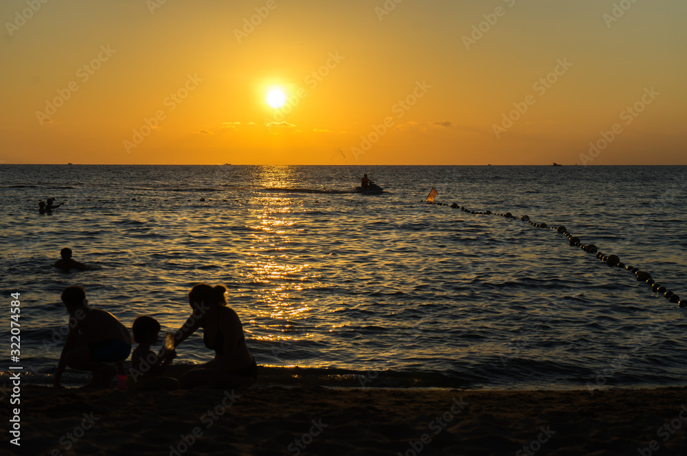 Beautiful sunset on the beach with people silhouttes on the Phu Quoc island.