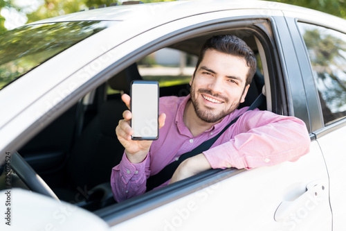 Smiling Handsome Man With Cellphone In Car