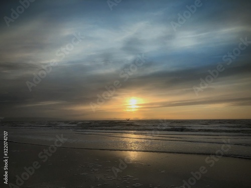 Sunset at the beach Julianadorp Netherlands. Coast Northsea. Waves