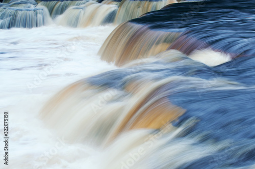Landscape of Lower Tahquamenon Falls captured with motion blur, summer, Michigan's Upper Peninsula, USA photo