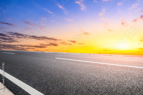 Empty asphalt road and sunset sky landscape in summer