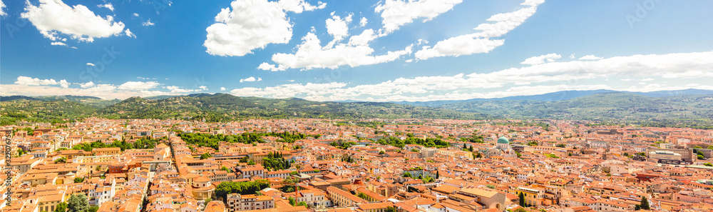 Beautiful panoramic view of Florence city aerial skyline - towers, basilicas, red-tiled roofs of houses and mountains on cityscape, Florence, Tuscany, Italy
