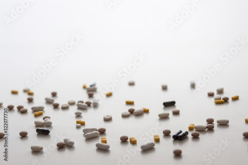 Scattered pills on a white background. Copy space. Nobody. Medicine.