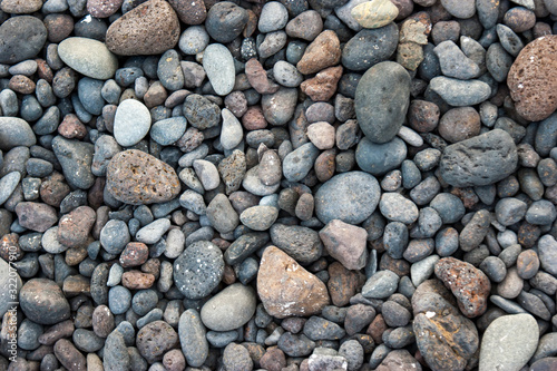 Colorful sea pebbles on the beach.
