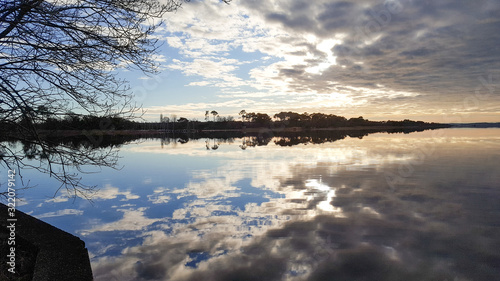 sunset sky cloud sun reflection in Biscarrosse lake sunrise France landes photo