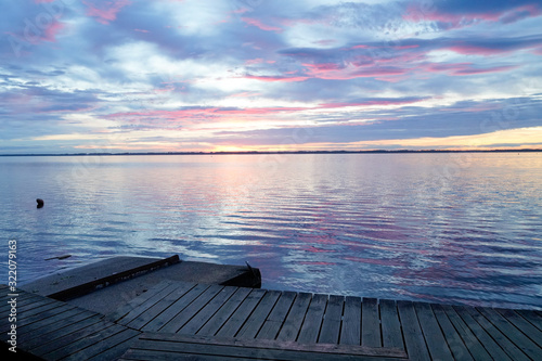 Biscarrosse lake at sunset with wooden boat pontoon jetty in france photo