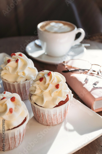 Cupcakes with hearts, coffee shop, romantic meeting for St. Valentine.