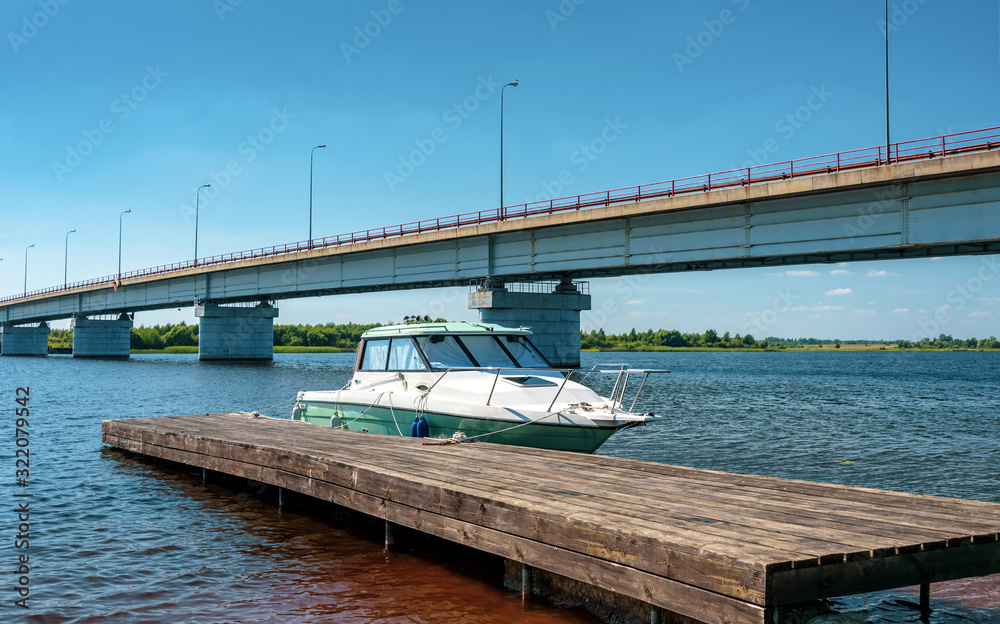 Fototapeta premium The small motorboat at the pier