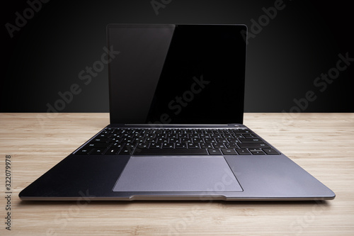 Wide angle shot of a laptop on table (ID: 322079978)