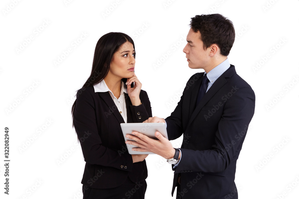 A young businessman is reprimanding a young business woman. He is looking at her. He is holding a tablet. He is pointing at it. She is looking at him. A young businessman is reprimanding a young business woman. He is looking at her. He is holding a tablet. He is pointing at it. She is looking at him.