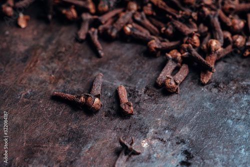 Dry cloves spices on the dark rustic background. Selective focus. shallow depth of field.