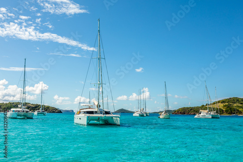 Turquoise colored sea with ancored yachts and catamarans, Tobago Cays tropical islands, Saint Vincent and the Grenadines, Caribbean sea © vadim.nefedov
