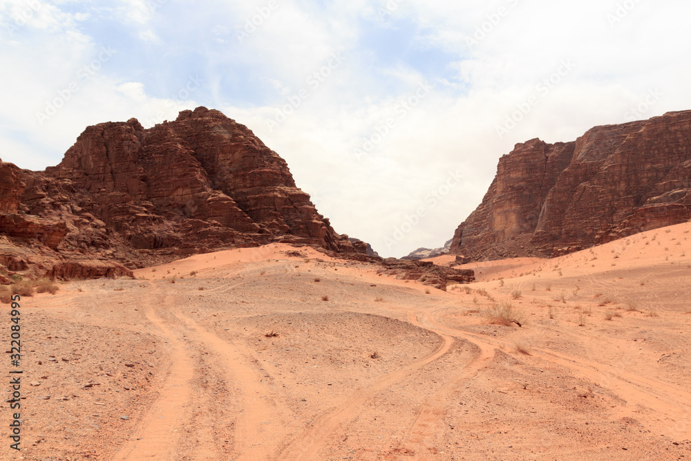 Fototapeta premium Wadi Rum desert panorama with dunes, mountains and sand that looks like planet Mars surface, Jordan