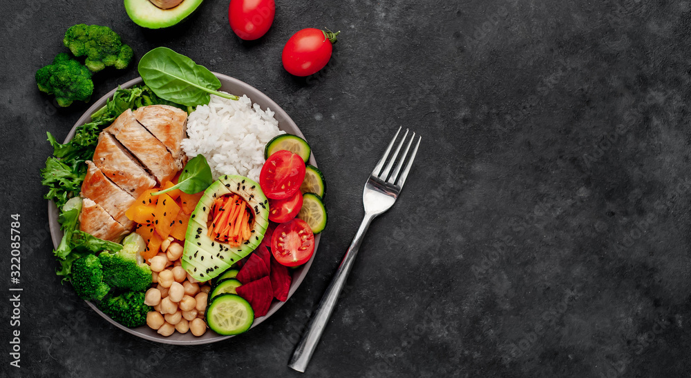 Bowl Buddha. rice, chicken breast, broccoli, pumpkin, avocado, chickpeas, carrots, cucumber, beets, a stone background Bowl Buddha. rice, chicken breast, broccoli, pumpkin, avocado, chickpeas, carrots, cucumber, beets, a stone background