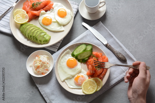 Healthy breakfast concept, fried eggs, avocado and smoked salmon, top view
