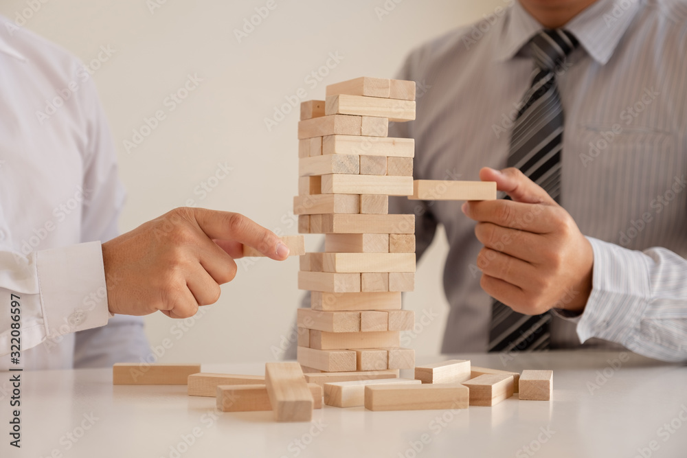 Image of hand holding blocks wood game to growing up of business. Risk of management and strategy plan Image of hand holding blocks wood game to growing up of business. Risk of management and strategy plan