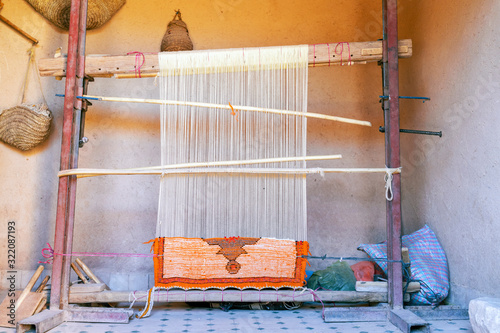фотографія Weaving loom with berber carpet in Morocco