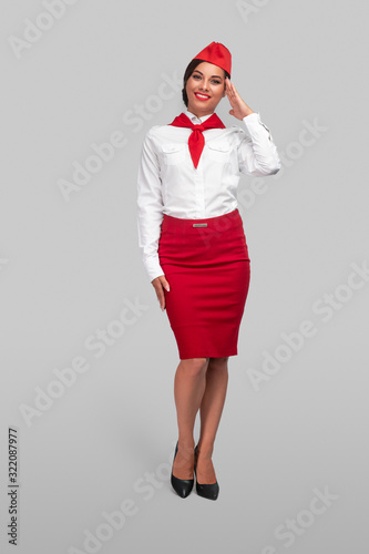 Positive flight attendant saluting for camera photo