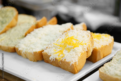 raw and fresh double cheese bread or toast white and yellow on tray and wood table for dessert or snack on breakfast for lunch and fast food in cafe restaurant and coffee shop or street bakery