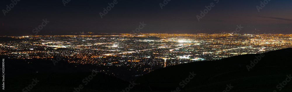 Panoramic night view of urban sprawl in San Jose, Silicon Valley, California; ; the downtown area buildings visible on the right