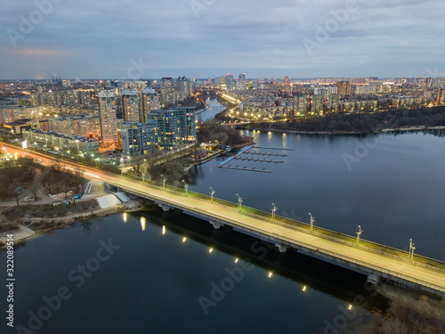 Aerial drone view. Automotive-subway bridge at dusk with backlight in Kiev.