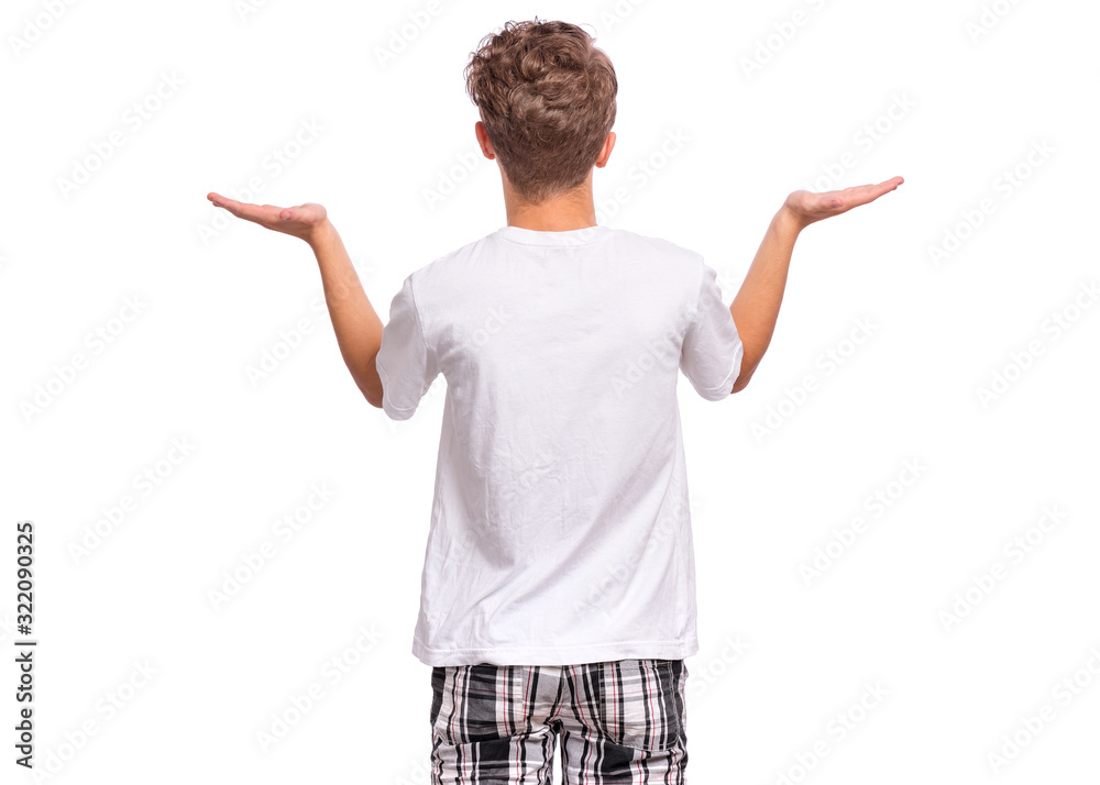 Back view. Teen boy showing both hands open palms, presenting and advertising comparison, balance. Child in white t-shirt asking you to make choice between two products, isolated on white background. Back view. Teen boy showing both hands open palms, presenting and advertising comparison, balance. Child in white t-shirt asking you to make choice between two products, isolated on white background.