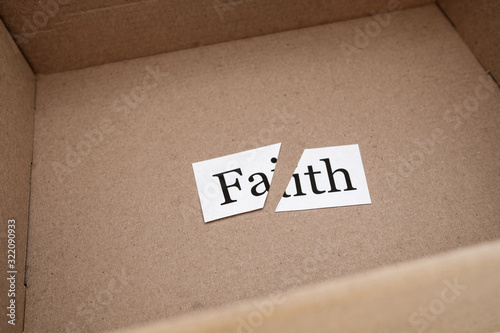 cut the word faith in an open box of beige color
