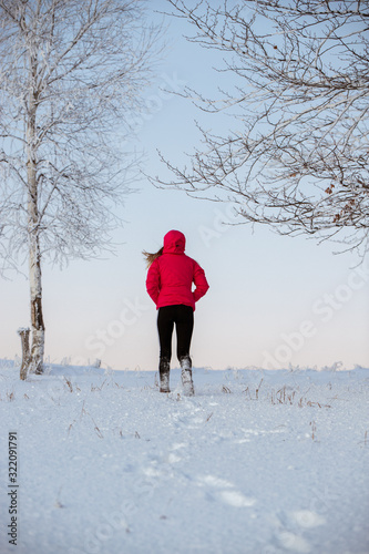 Young girl in warm clothes ...